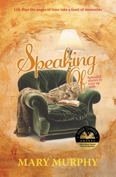 Plush comfy green velvet chair, with blanket strewn over armrest, book open on chair cushion and reading lamp behind. Background golden yellow.